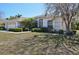 Well-manicured lawn and shrubbery surround this single-story home with a side-entry garage at 610 147Th St E, Bradenton, FL 34212