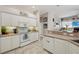 A kitchen with white cabinets and tile floors at 610 147Th St E, Bradenton, FL 34212