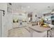 A kitchen with white cabinets, tile floors, and a ceiling fan at 610 147Th St E, Bradenton, FL 34212