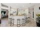 A kitchen with bar seating, white cabinets, and tile floors at 610 147Th St E, Bradenton, FL 34212