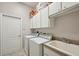 A laundry room with washer, dryer, sink, and cabinets at 610 147Th St E, Bradenton, FL 34212