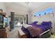 A main bedroom with large bed and a view of the pool at 610 147Th St E, Bradenton, FL 34212