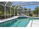 Relaxing screened-in pool area with lounge seating, tile accents, and beautiful outdoor views at 610 147Th St E, Bradenton, FL 34212