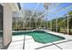 Inviting screened-in pool area with lounge chairs and lush greenery, perfect for relaxation and outdoor enjoyment at 610 147Th St E, Bradenton, FL 34212