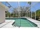 Inviting screened-in pool featuring tile accents, integrated steps, and ample space for outdoor lounging at 610 147Th St E, Bradenton, FL 34212
