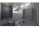Contemporary bathroom with a sleek vanity, a minimalist mirror, and a shower-tub combo at 610 Hibiscus Way, Longboat Key, FL 34228