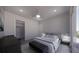 Comfortable bedroom with a walk-in closet, a dark wood dresser, and an outdoor view at 610 Hibiscus Way, Longboat Key, FL 34228