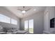 Bright bedroom with a ceiling fan, two large windows, and an outdoor balcony at 610 Hibiscus Way, Longboat Key, FL 34228