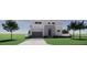 Modern two-story home featuring a gray exterior, a two-car garage, and clean landscaping at 610 Hibiscus Way, Longboat Key, FL 34228