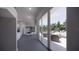 Hallway leading to an outdoor patio, featuring modern decor and a dining area at 610 Hibiscus Way, Longboat Key, FL 34228