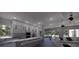 Bright, modern kitchen with a spacious island, stainless steel appliances, and open living area at 610 Hibiscus Way, Longboat Key, FL 34228