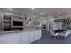 Open concept living room featuring a fireplace, modern lighting, and kitchen in the background at 610 Hibiscus Way, Longboat Key, FL 34228