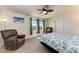 Comfortable bedroom features a ceiling fan and a leather chair at 6138 100Th E Ave, Parrish, FL 34219