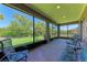 A screened in lanai has brick pavers and comfortable patio furniture with views to the backyard at 6138 100Th E Ave, Parrish, FL 34219
