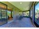 Screened lanai with brick pavers, comfortable seating, and view of the backyard at 6138 100Th E Ave, Parrish, FL 34219