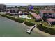 Aerial view showcasing community with pool, dock, and surrounding lush landscaping by the water at 6269 Palma Del Mar S Blvd # 308, St Petersburg, FL 33715