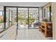 Open-concept kitchen with access to a screened-in balcony overlooking lush greenery at 6269 Palma Del Mar S Blvd # 308, St Petersburg, FL 33715