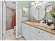 Bathroom with granite countertops, white cabinets, round mirrors, and a tiled walk-in shower at 6269 Palma Del Mar S Blvd # 308, St Petersburg, FL 33715