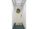 Front door decorated with a flower wreath and butterfly door mat at 6269 Palma Del Mar S Blvd # 308, St Petersburg, FL 33715