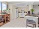 Well-lit kitchen features white appliances and cabinets, tile flooring, breakfast bar, and recessed lighting at 6269 Palma Del Mar S Blvd # 308, St Petersburg, FL 33715
