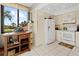 Bright kitchen features white appliances, cabinetry, tile floors, and a large window at 6269 Palma Del Mar S Blvd # 308, St Petersburg, FL 33715