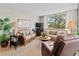 Brightly lit living room with wicker seating, a large window, and wood flooring at 6269 Palma Del Mar S Blvd # 308, St Petersburg, FL 33715