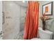Updated walk-in shower features a tiled surround, mosaic accents, and an orange shower curtain at 6269 Palma Del Mar S Blvd # 308, St Petersburg, FL 33715
