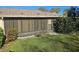 View of the sunroom from the exterior with grass yard at 6403 Heritage Ln # 6403, Bradenton, FL 34209