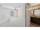 This lovely bathroom features a marble vanity, updated fixtures, and a framed mirror at 6412 Rosefinch Ct # 102, Lakewood Ranch, FL 34202