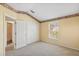 Well-lit bedroom featuring wall-to-wall closet and a window providing natural light at 6412 Rosefinch Ct # 102, Lakewood Ranch, FL 34202