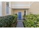 Charming entrance featuring a blue front door and lush landscaping at 6412 Rosefinch Ct # 102, Lakewood Ranch, FL 34202