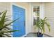 Charming home entrance featuring a bright blue door framed by white trim and fresh plants at 6412 Rosefinch Ct # 102, Lakewood Ranch, FL 34202