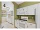 Open kitchen featuring white cabinets, appliances, and countertops, with tile flooring at 6412 Rosefinch Ct # 102, Lakewood Ranch, FL 34202
