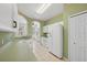 Bright kitchen featuring white appliances and cabinets and light green walls and countertops at 6412 Rosefinch Ct # 102, Lakewood Ranch, FL 34202