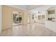 Bright living and dining area combo with sliding doors to the patio, a ceiling fan, and built in cabinets at 6412 Rosefinch Ct # 102, Lakewood Ranch, FL 34202