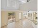 Aerial view of the living area with a sliding door to the patio, built in cabinets, and tile flooring at 6412 Rosefinch Ct # 102, Lakewood Ranch, FL 34202
