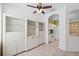 Open-concept area with ceiling fan and white shelving looking into kitchen at 6412 Rosefinch Ct # 102, Lakewood Ranch, FL 34202