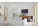 Bright living room with a plush white sofa, modern entertainment center, and plenty of natural light at 6412 Rosefinch Ct # 102, Lakewood Ranch, FL 34202