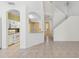 Open-concept layout showcasing kitchen view from living area and staircase access at 6412 Rosefinch Ct # 102, Lakewood Ranch, FL 34202
