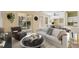 Bright living room features neutral decor, a white sofa, and lots of natural light from the sliding glass doors at 6412 Rosefinch Ct # 102, Lakewood Ranch, FL 34202