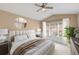 Cozy main bedroom with a neutral color palette, vaulted ceiling, and large window for natural light at 6412 Rosefinch Ct # 102, Lakewood Ranch, FL 34202