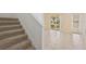 Carpeted staircase leading to a bright living area with sliding glass doors at 6412 Rosefinch Ct # 102, Lakewood Ranch, FL 34202