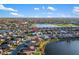Overhead view showcases a community with lake access, green spaces, and diverse home styles at 664 Silk Oak Dr, Venice, FL 34293