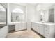 Bathroom with white vanities, large mirrors, and tile flooring at 664 Silk Oak Dr, Venice, FL 34293