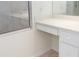 Bright bathroom with white vanity, drawers and shower at 664 Silk Oak Dr, Venice, FL 34293