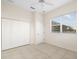 Neutral bedroom with a large closet, a window, tiled flooring, and an overhead light at 664 Silk Oak Dr, Venice, FL 34293