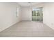 Bedroom boasts tile flooring, a ceiling fan, and access to a patio via sliding glass doors at 664 Silk Oak Dr, Venice, FL 34293