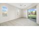 Bright bedroom with tile flooring, a ceiling fan, and sliding glass doors at 664 Silk Oak Dr, Venice, FL 34293