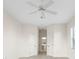 A bright bedroom features a ceiling fan, tile floors and white walls at 664 Silk Oak Dr, Venice, FL 34293
