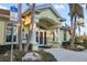 Clubhouse entrance featuring white pillars, landscaping and designated handicap parking at 664 Silk Oak Dr, Venice, FL 34293